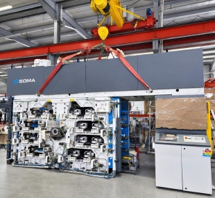 Installation of a printing press assembly at a packaging production facility